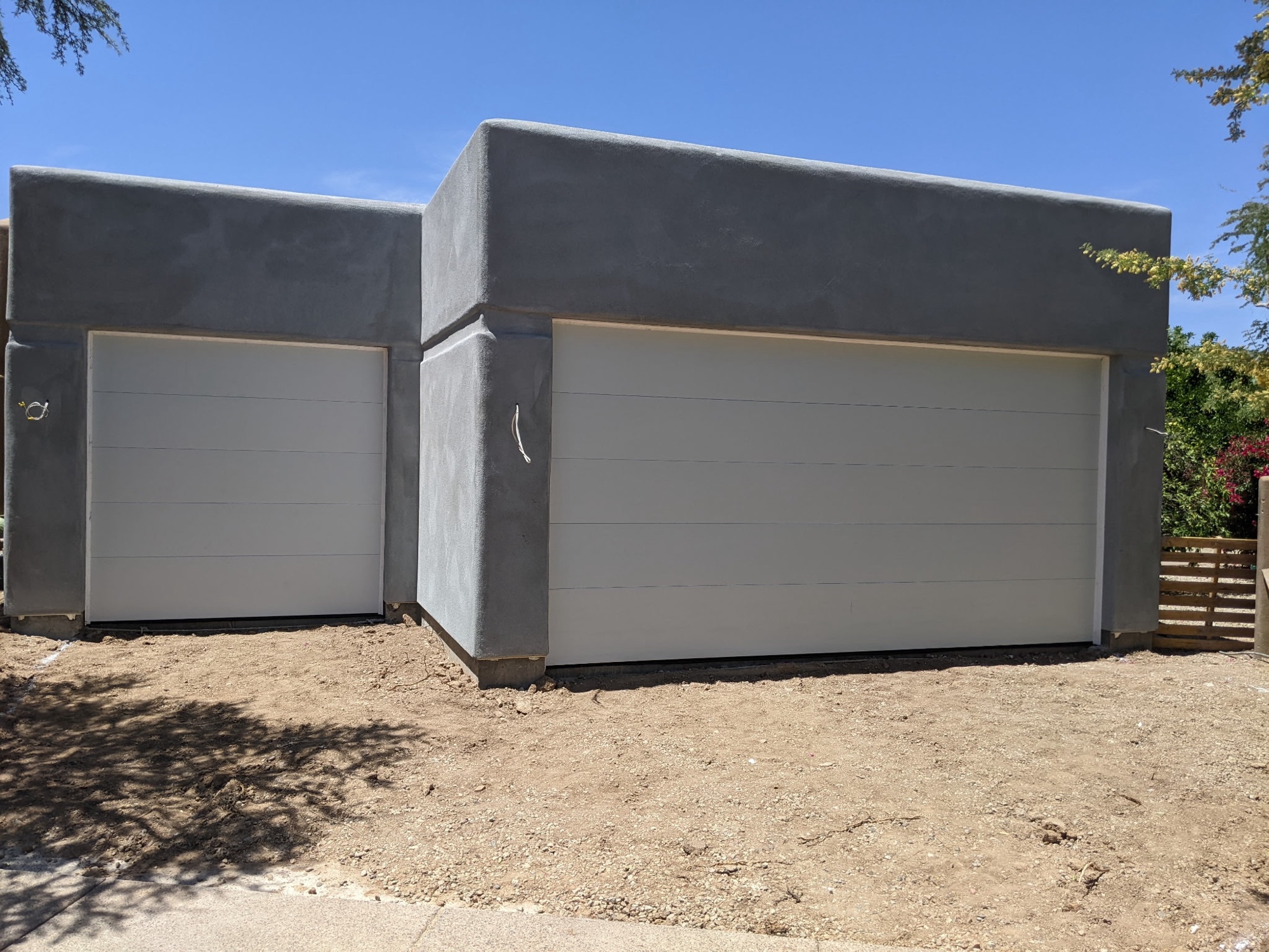 White modern insulated doors on contemporary stucco build